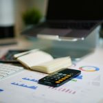 Agentic AI Banking training – workspace with laptop, charts and calculator