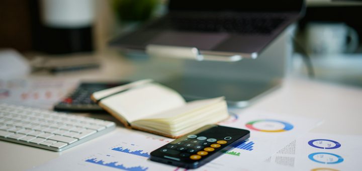 Agentic AI Banking training – workspace with laptop, charts and calculator